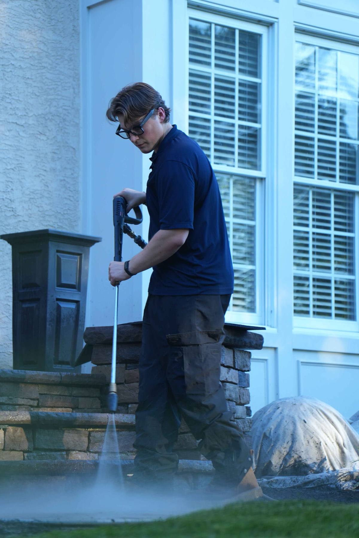 Petra Power Solutions' owner soft-washing the exterior of a home in Bucks County, PA